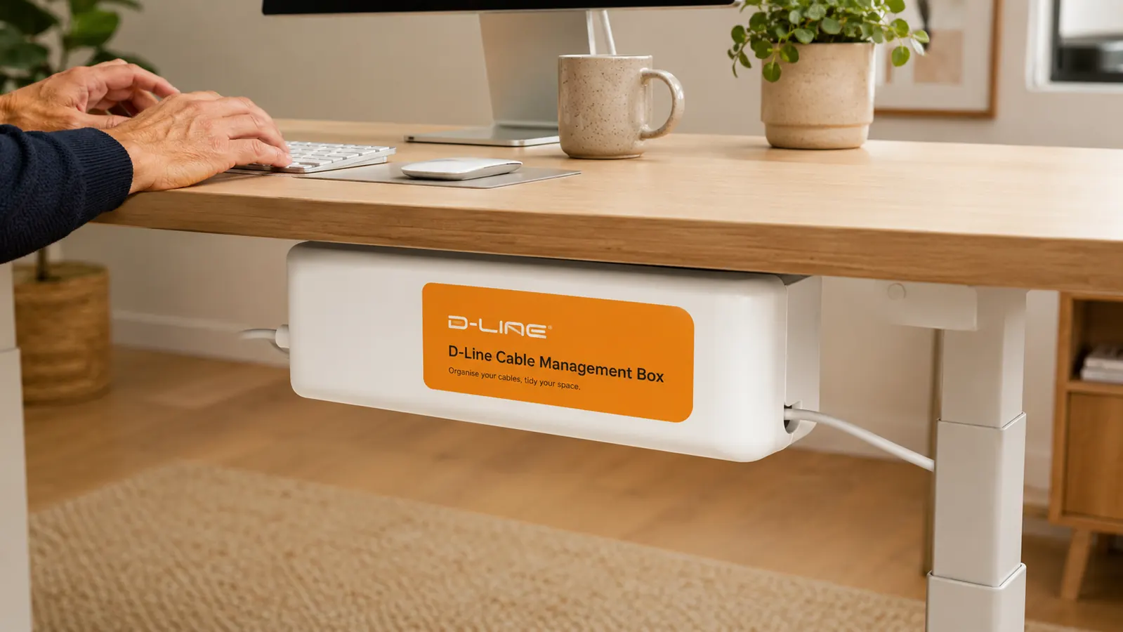 D-Line cable management box mounted under a standing desk with cords neatly exiting through side openings