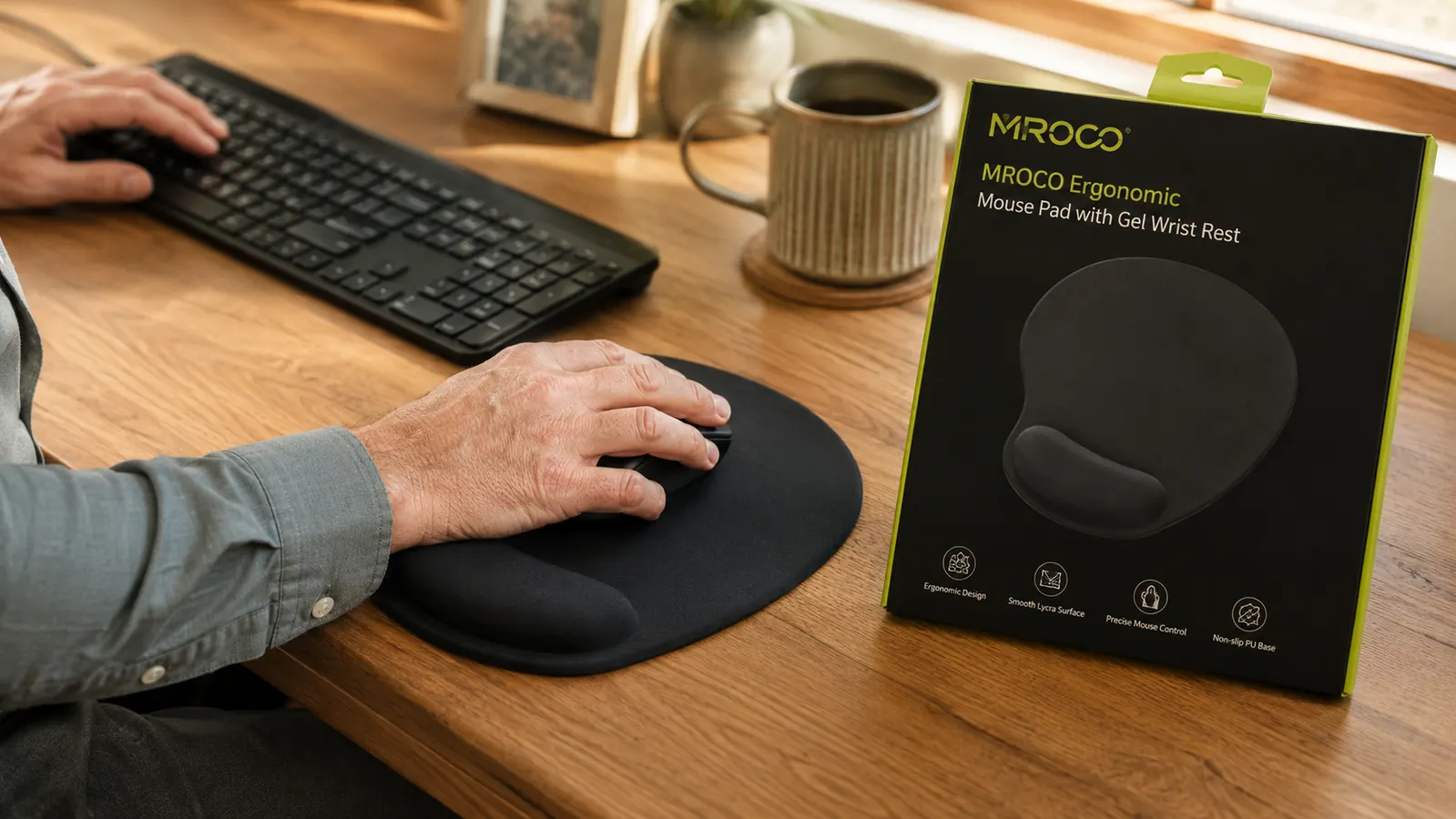 Person's left hand using a mouse on an ergonomic mouse pad, showing how a left-handed user positions the wrist on the gel cushion